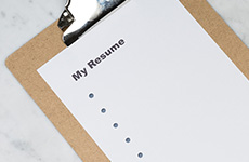 Pen and clipboard with a piece of paper on it titled "My Resume".