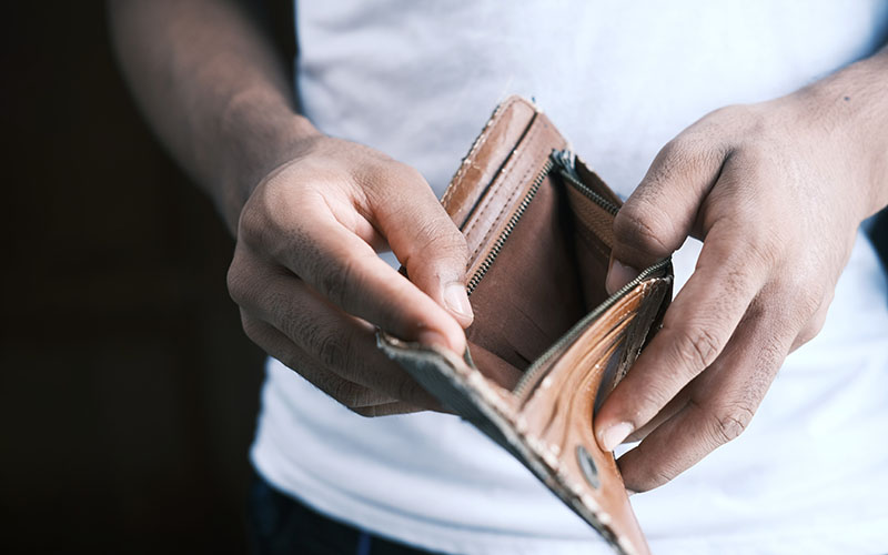 Man holding empty wallet.